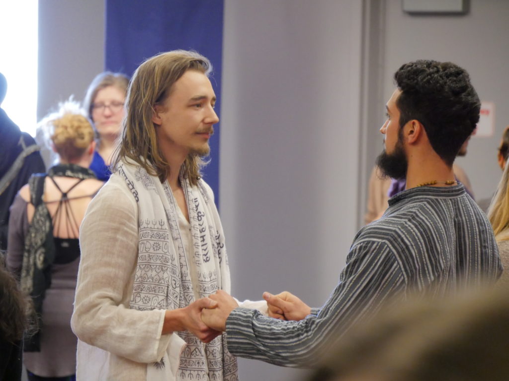 Two men holding hands and looking into each other's eyes