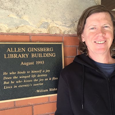 Thurston Moore photo in front of the Allen Ginsberg Library sign
