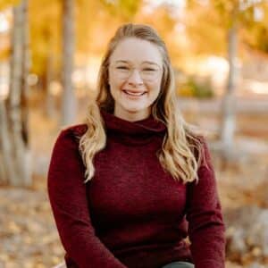 Kelly Zepelin standing in a forest in autumn