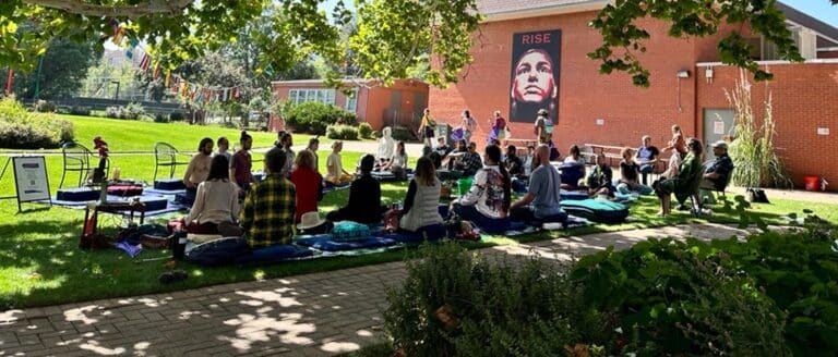 Students meditating on the Naropa Green for the sit-a-thon.