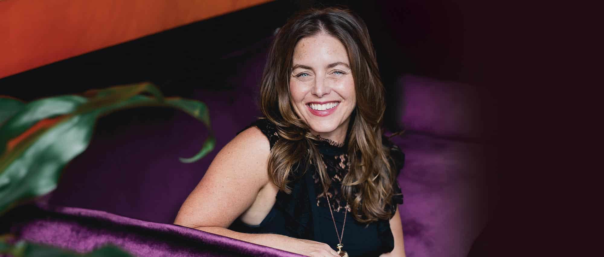 Bari Tessler on a purple velvet couch in Montreal