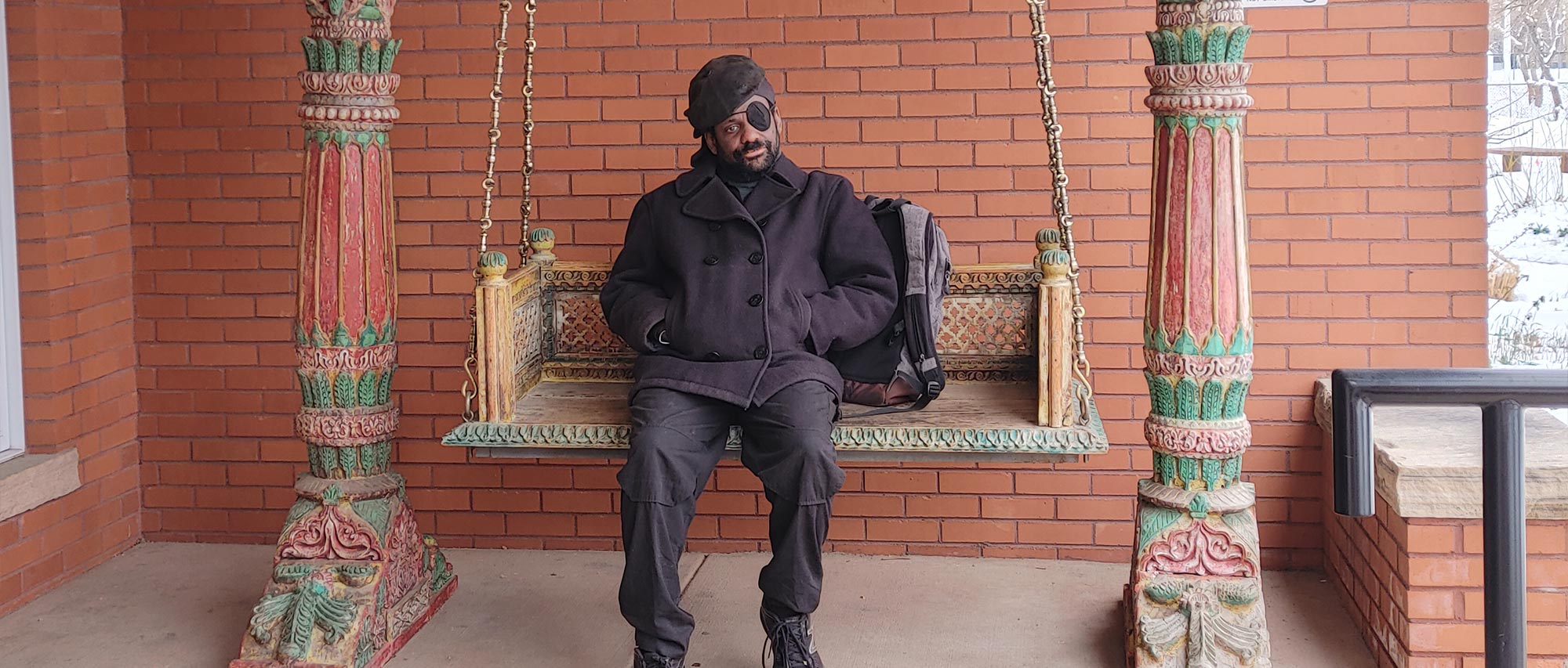 Kyva on the swing at the entrance to the Allen Ginsberg Library