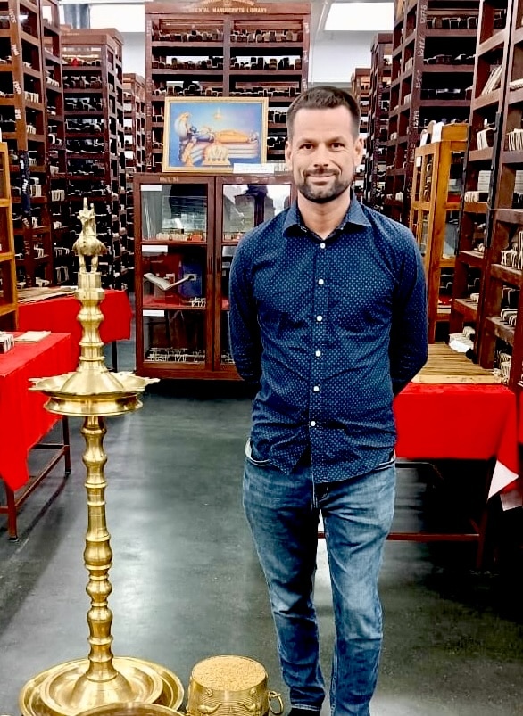 Dr. Ben Williams in the Oriental Research Institute and Manuscripts Library at the University of Kerala, surrounded by 65,000 manuscripts.