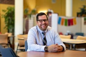 Jeremy Moore sitting at a table in the student center