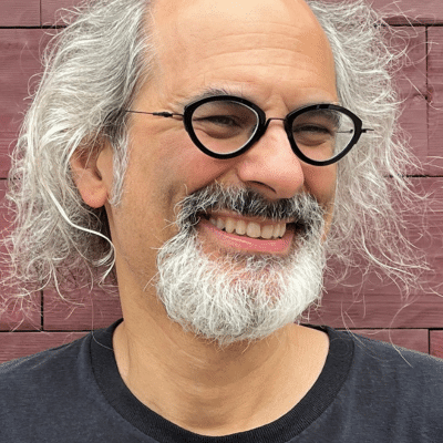 tony trigilio in front of red brick wall