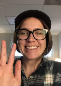 Lisa Wallace head shot with hand wave